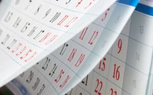 Calendar pages flipping, with dates in black and red