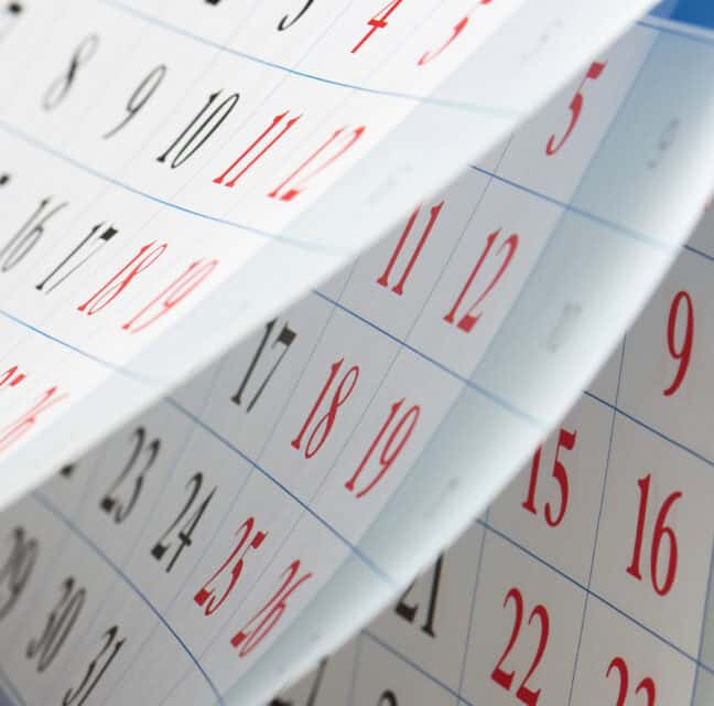 Calendar pages flipping, with dates in black and red