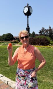 Catherine Potechin holding the ball from her first hole-in-one