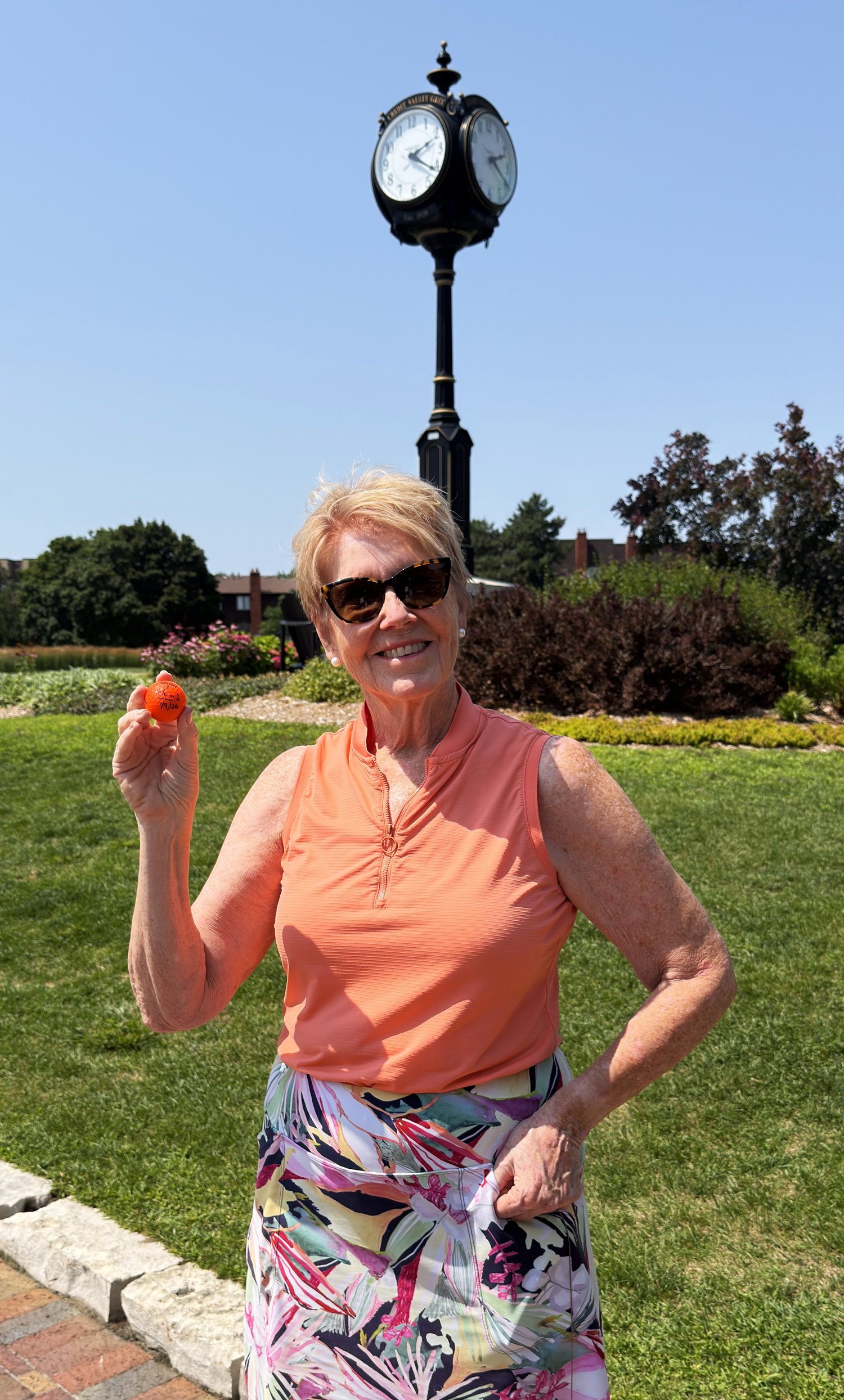 Catherine Potechin holding the ball from her first hole-in-one