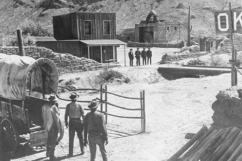 Old West street scene with a covered wagon outside the O.K. Corral