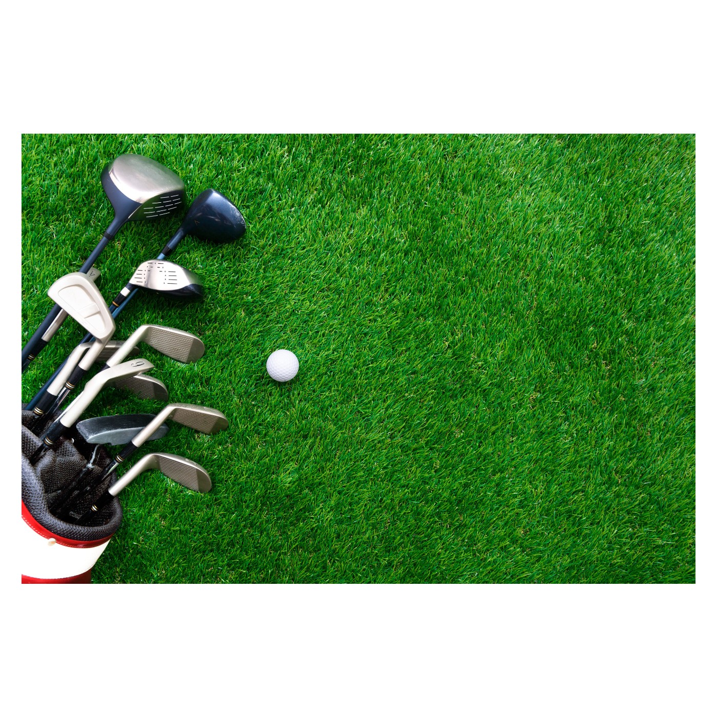 Golf ball and club in a bag on the grass