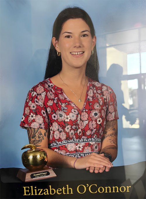 Elizabeth O'Connor seated beside her Golden Apple award
