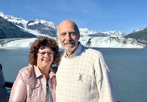 Karen and Dennis Jensen in front of an Alaskan glacier