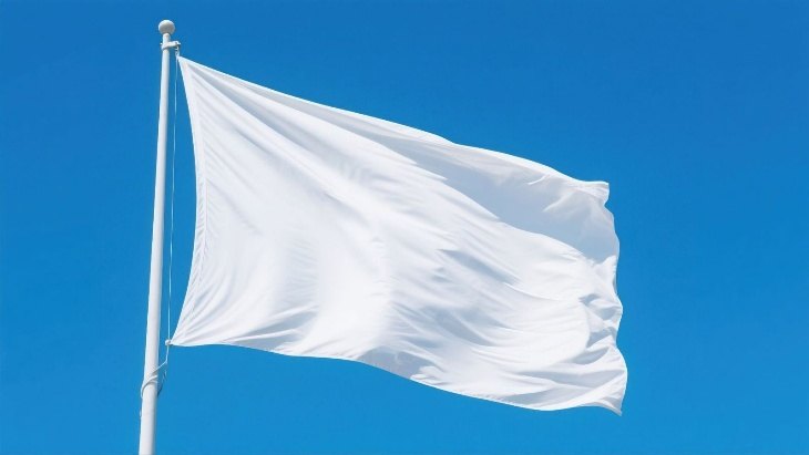 Plain white flag flying against a blue sky